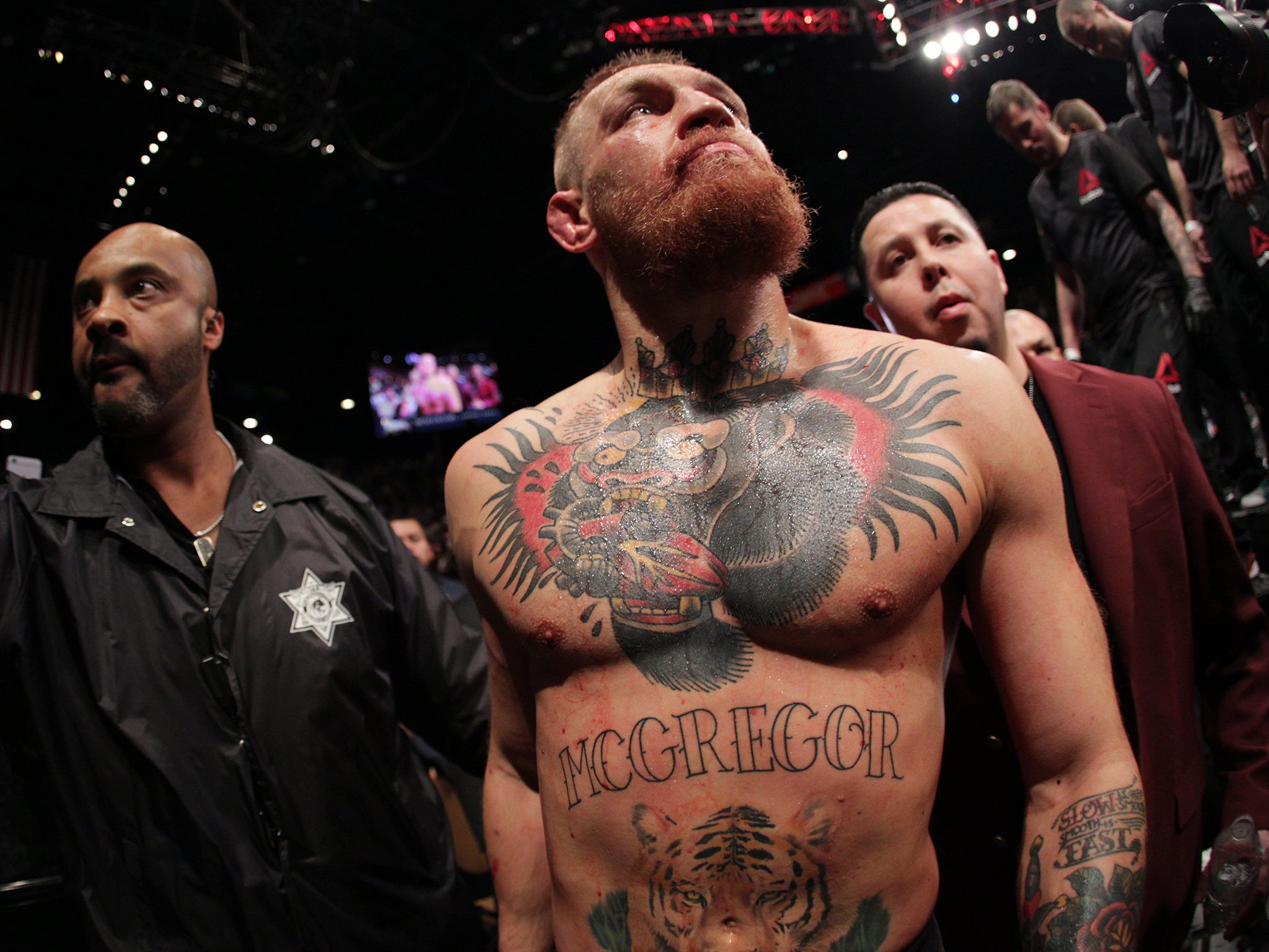 Conor McGregor walks out of the Octagon following his defeat to Nick Diaz