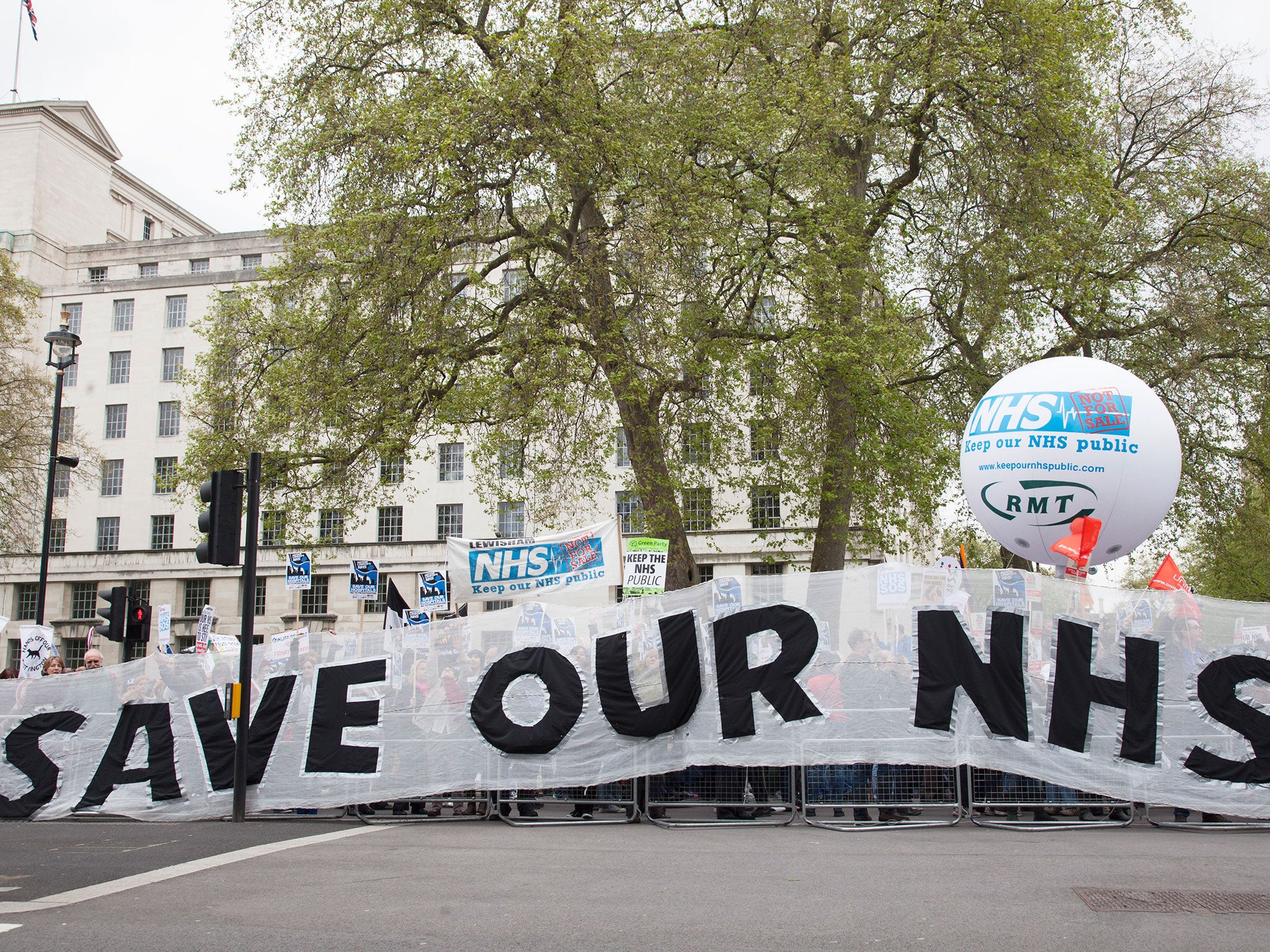 Protesters march in a demonstration against NHS funding cuts. NHS trusts will face a combined deficit of £2.5bn when the current financial year ends