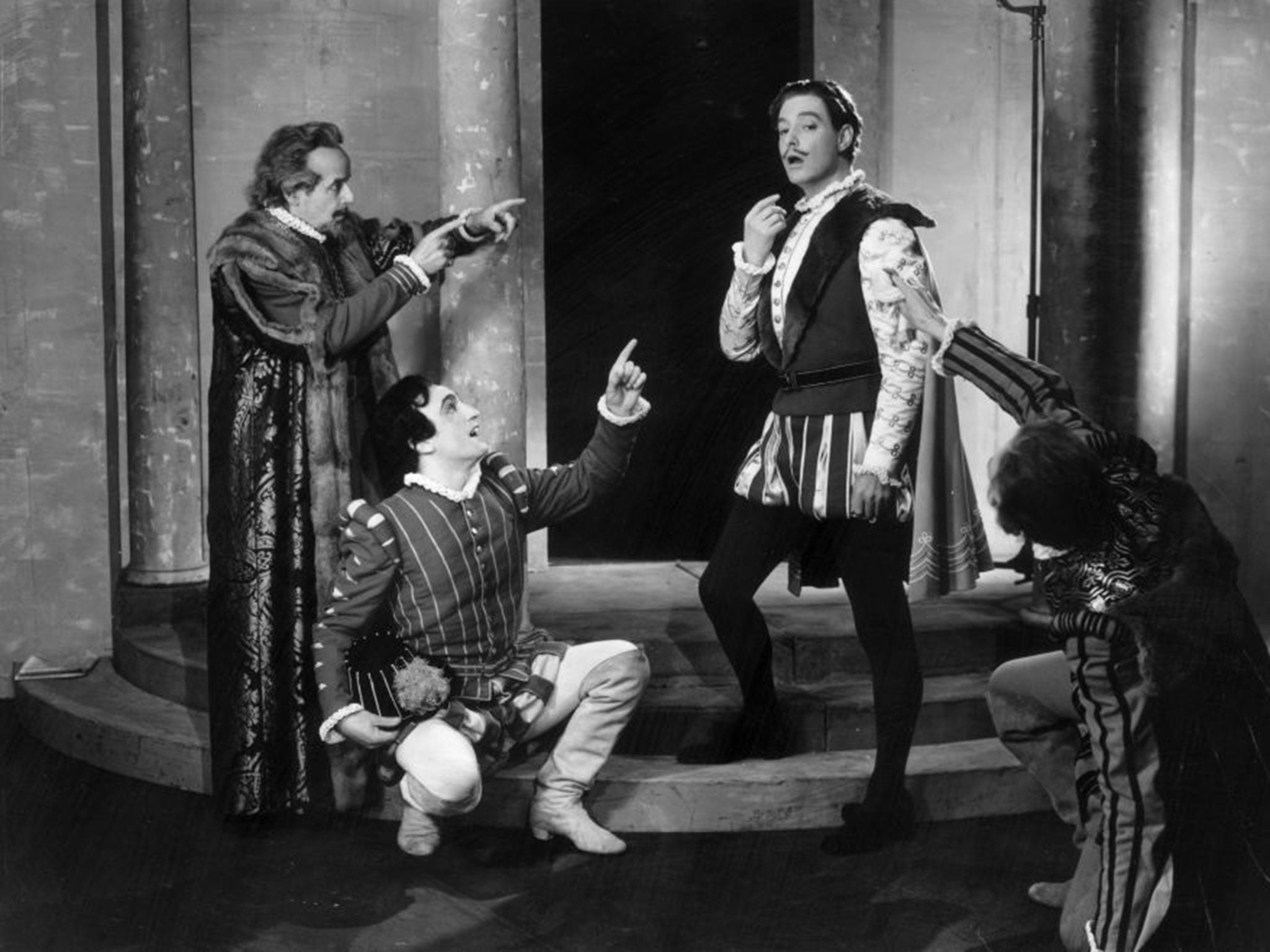 English actor Robert Donat, second from right, as 'Benedick' in a production at the Aldwych Theatre, London in 1946
