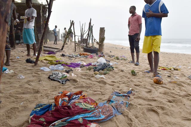 Locals look at the belongings left behind by people who fled the gunman in Grand Bassam