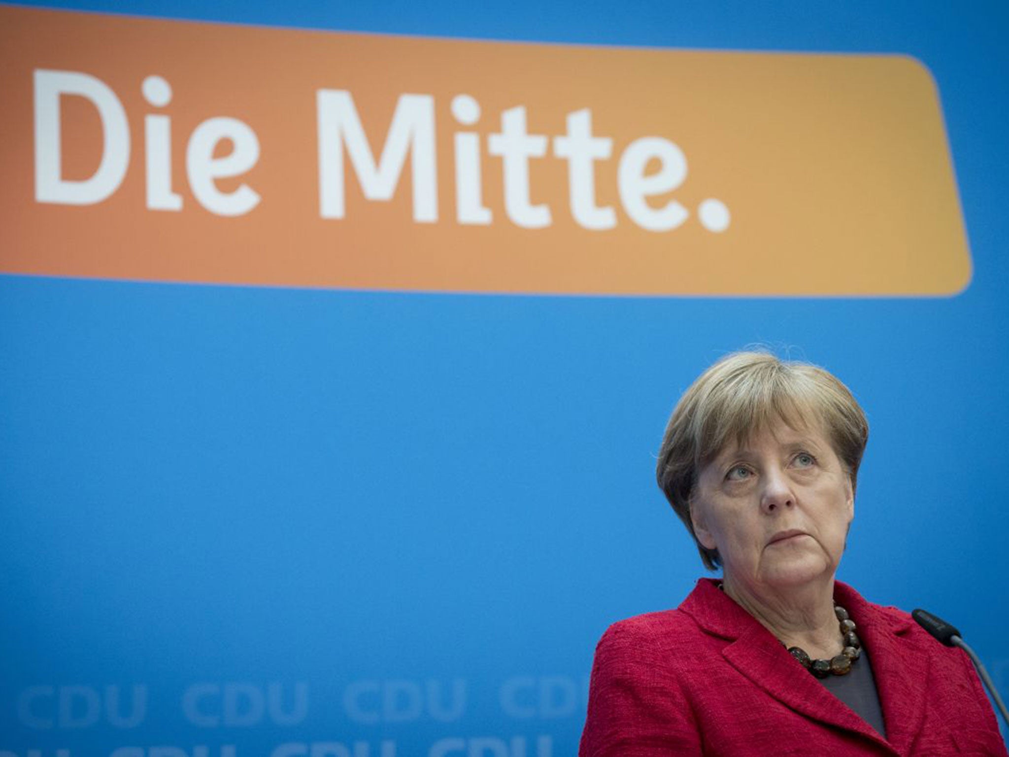 Angela Merkel looks shaken as she addresses the media in Berlin in the wake of her poll humiliation