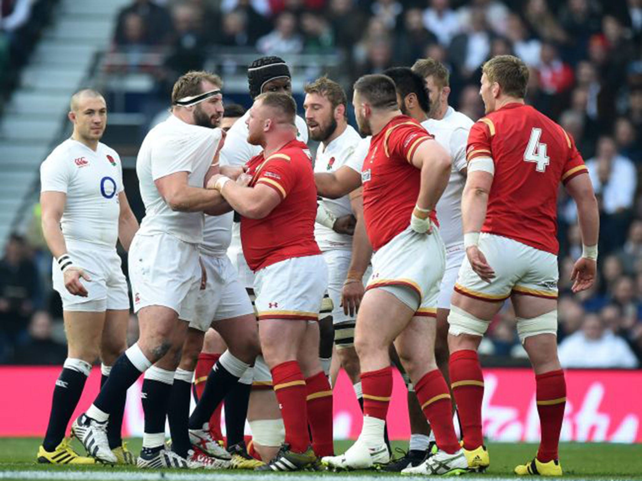 Joe Marler, left, and Wales’ Samson Lee get up close and personal on Saturday