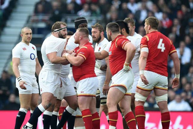 Joe Marler, left, and Wales’ Samson Lee get up close and personal on Saturday