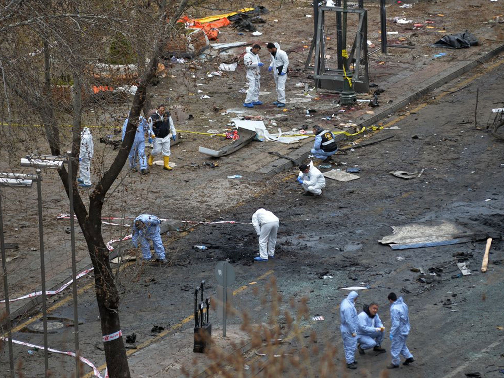 Police forensic officials work at the explosion site in Ankara