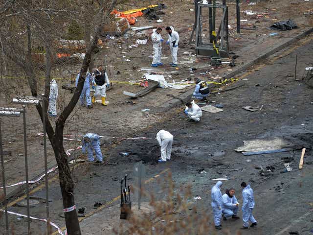 Police forensic officials work at the explosion site in Ankara