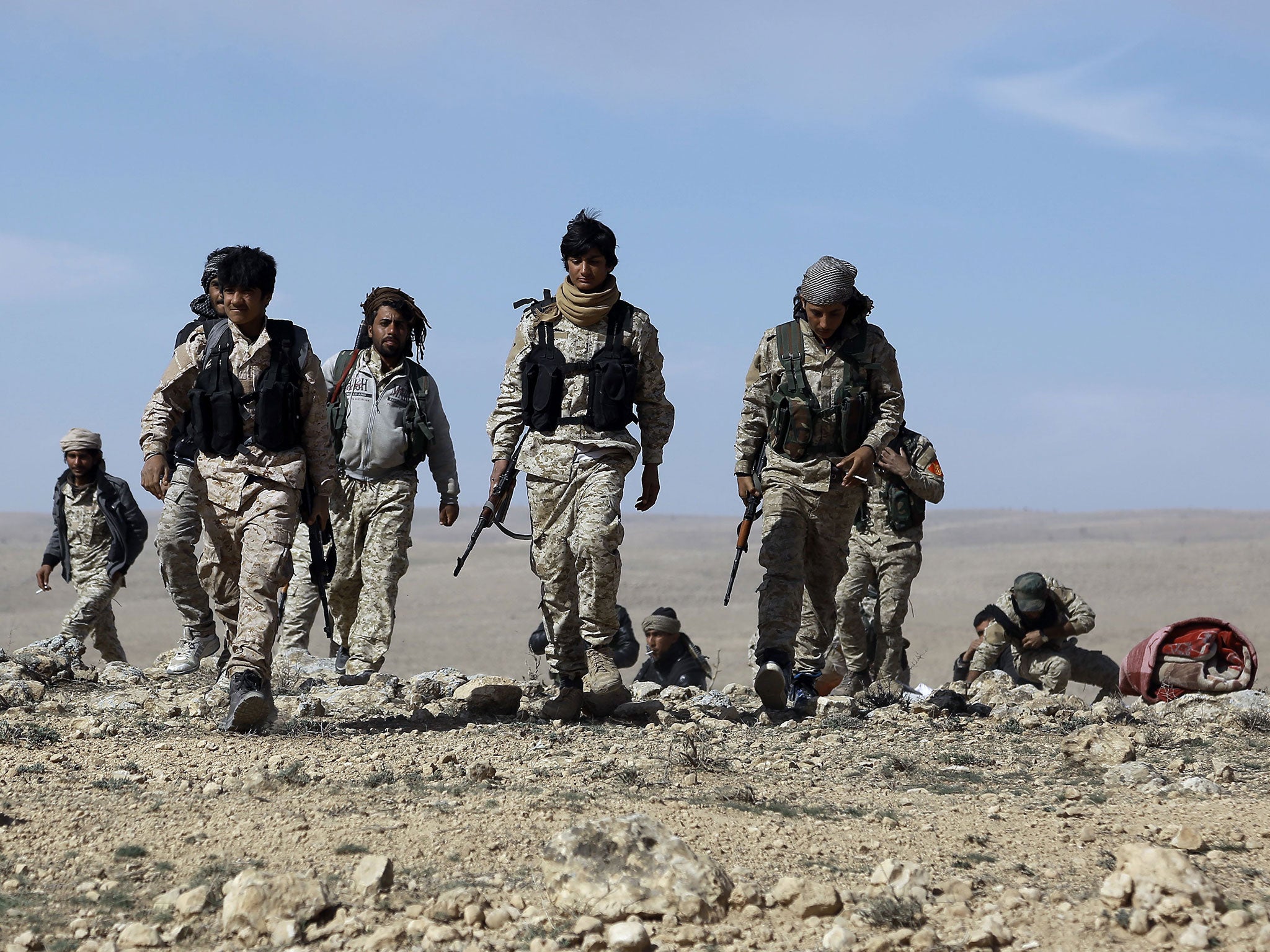 Fighters from the Syrian Democratic Forces (SDF) gather on the outskirts of the town of al-Shadadi in the northeastern Syrian province of Hasakeh, on 19 February, 2016
