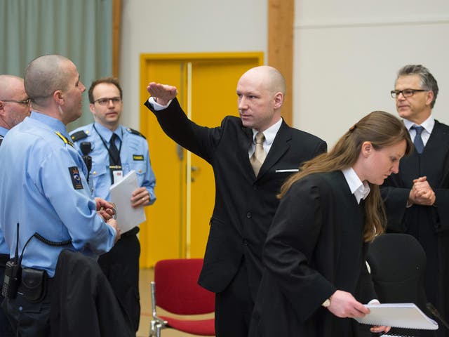 Anders Behring Breivik makes a Nazi salute as he arrives to a makeshift court in Skien prisons gym,ome 130 km south west of Oslo.