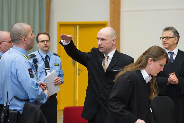 Anders Behring Breivik makes a Nazi salute as he arrives to a makeshift court in Skien prisons gym,ome 130 km south west of Oslo.