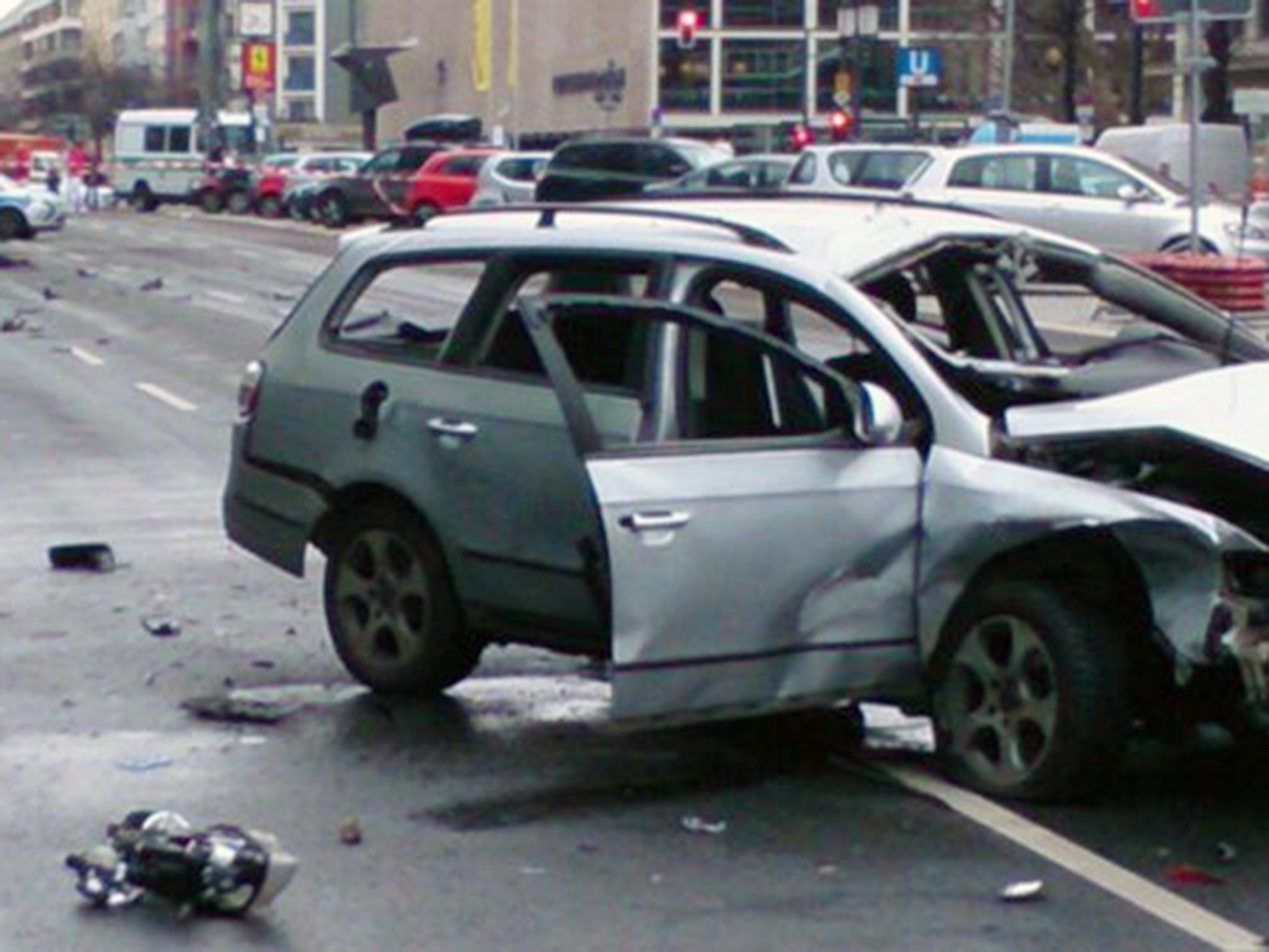 Berlin Police uploaded a picture of the wreckage of a silver VW Passat with its windows blown out and its front end smashed in