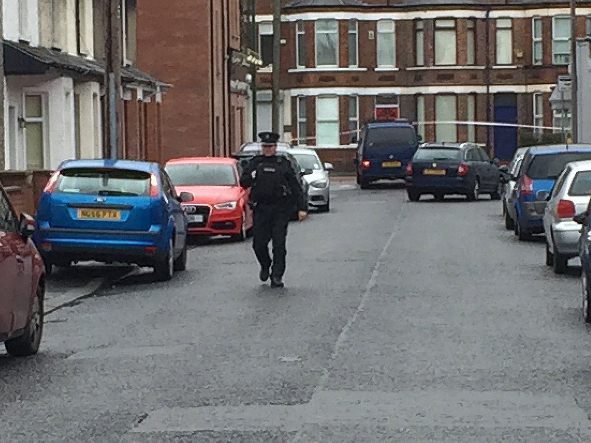 Police approach the Van under which a device exploded in east Belfast.