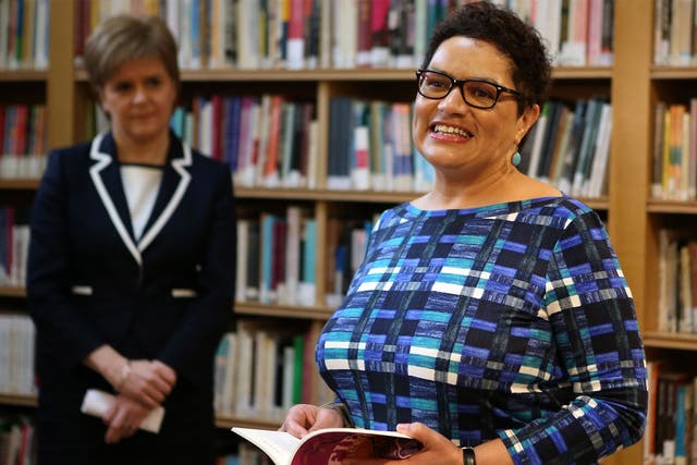 First Minister Nicola Sturgeon listens as Jackie Kay reads a poem at the Scottish Poetry Library in Edinburgh