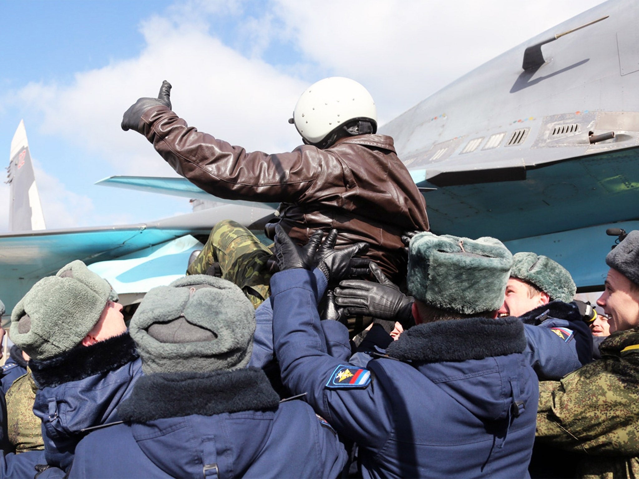 A Russian pilot is tossed into the air during an official greeting ceremony at an airbase outside the city of Voronezh, 360 miles south east of Moscow