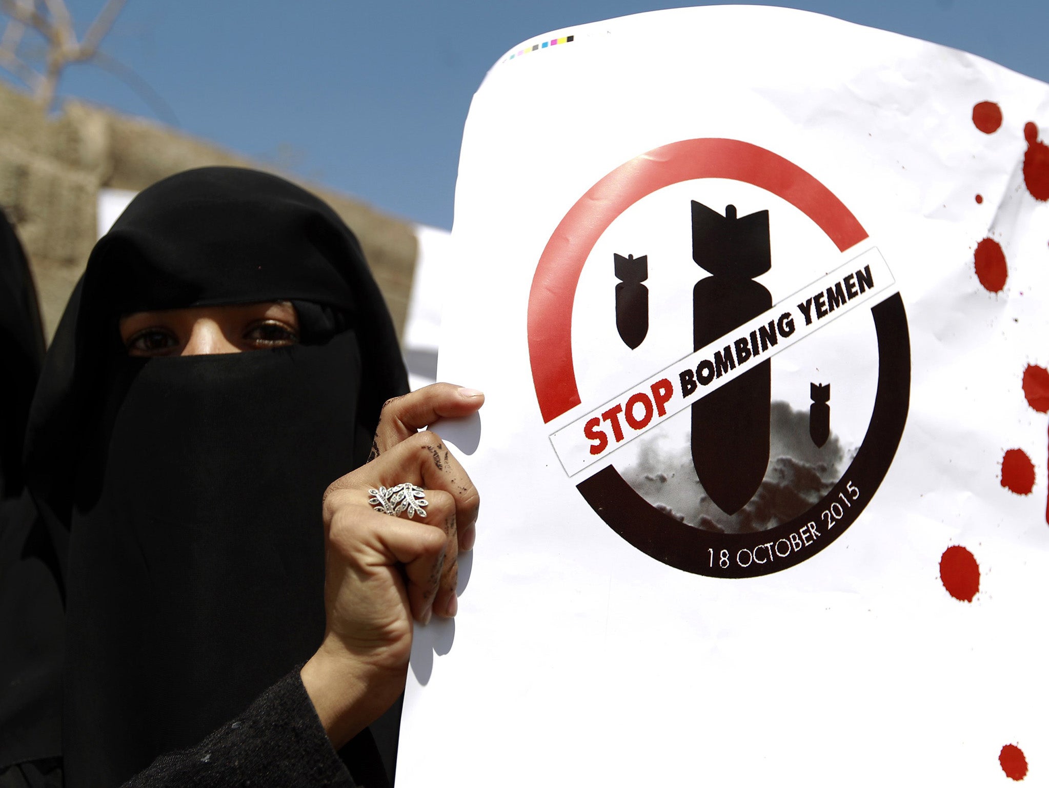 A Yemeni woman holds a slogan during a protest in front of the United Nations office in the capital Sanaa