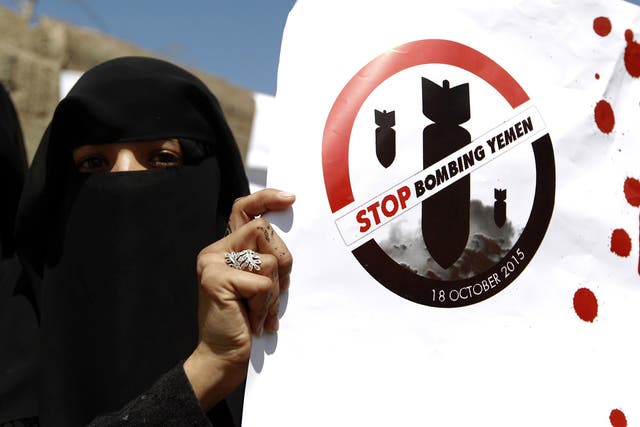 A Yemeni woman holds a slogan during a protest in front of the United Nations office in the capital Sanaa