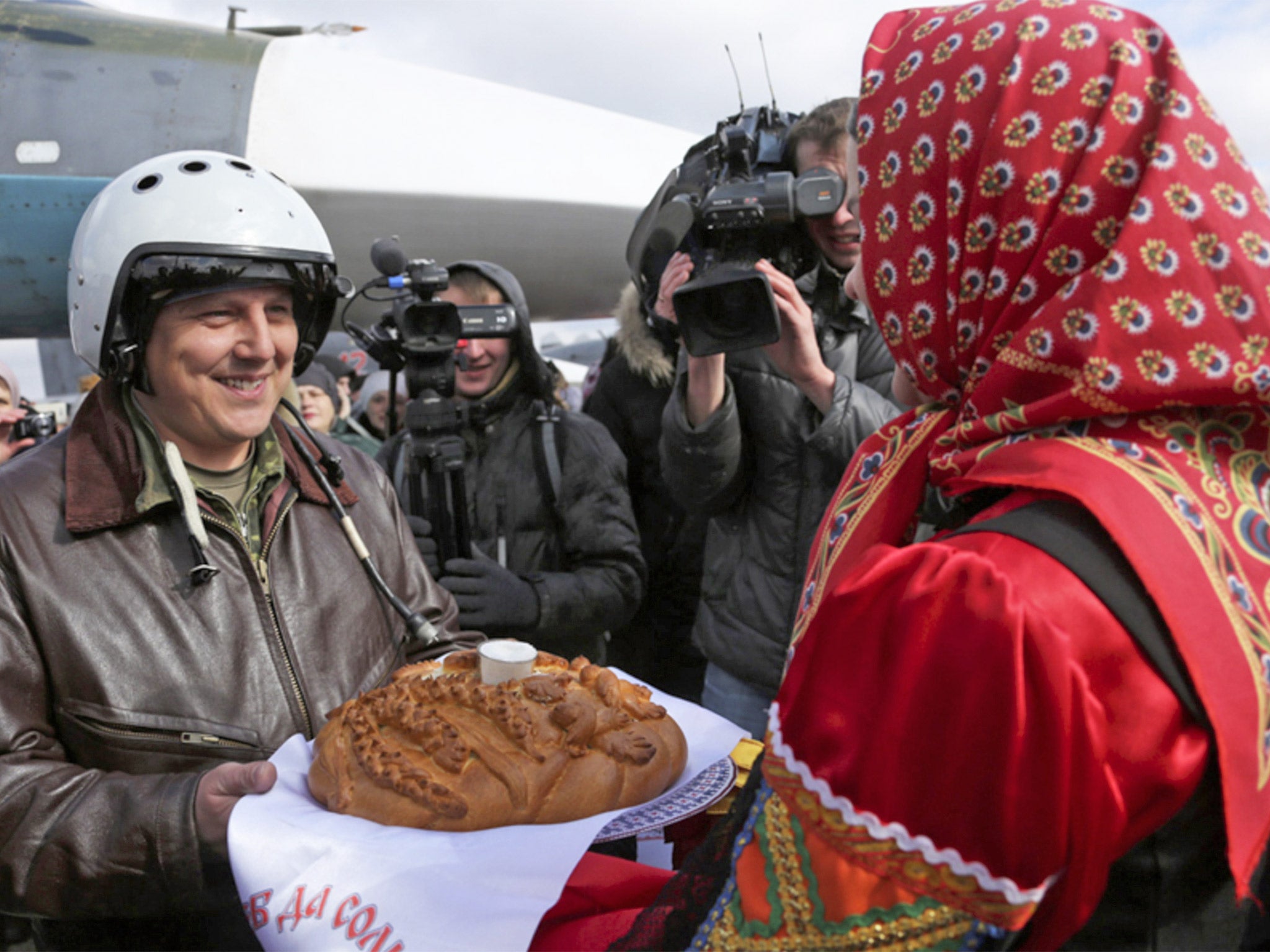 A pilot is welcomed at Voronezh air base after arriving back from Syria