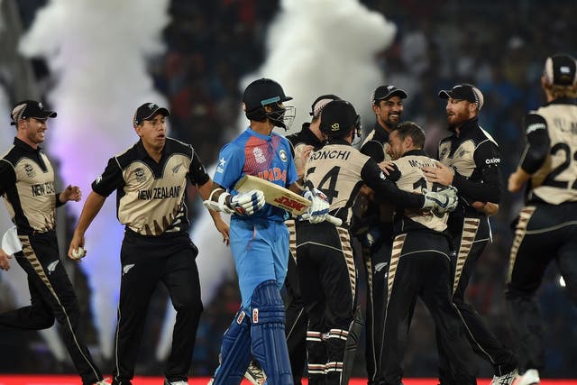 New Zealand players celebrate after the wicket of India's batsman Shikhar Dhawan