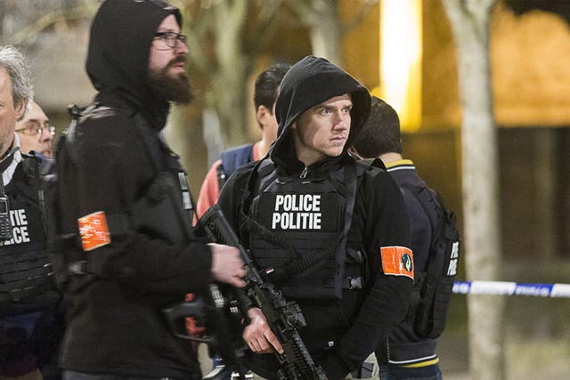 Armed officers secure an area during the police operation in Brussels