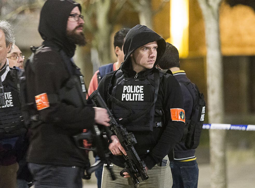 Armed officers secure an area during the police operation in Brussels