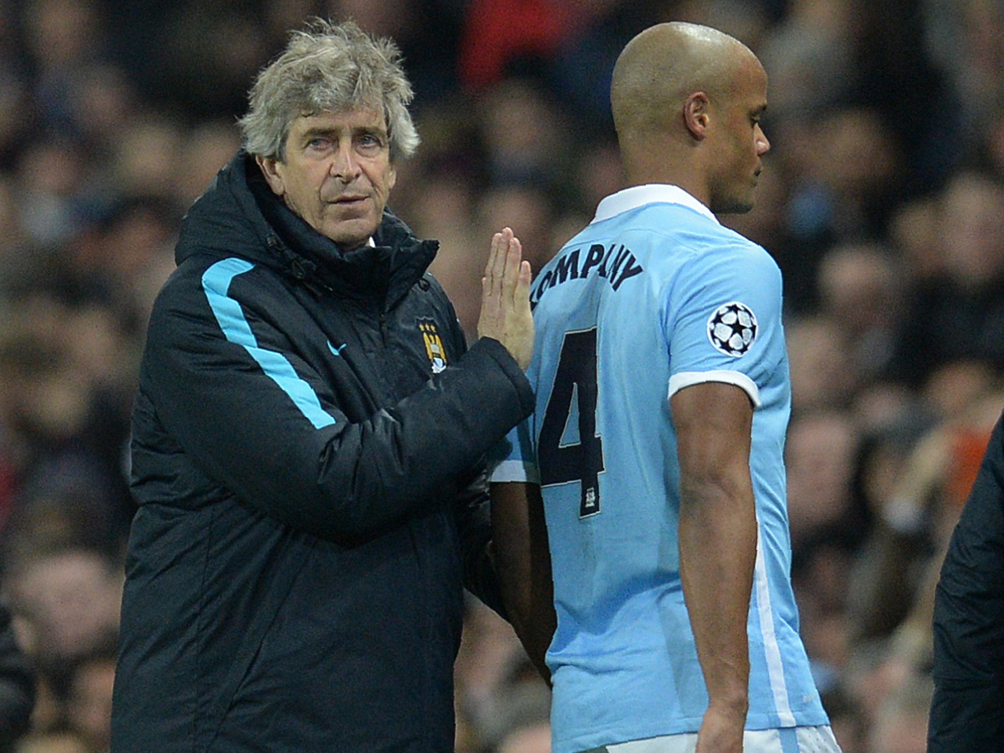Pellegrini consoles Kompany as he leaves the pitch