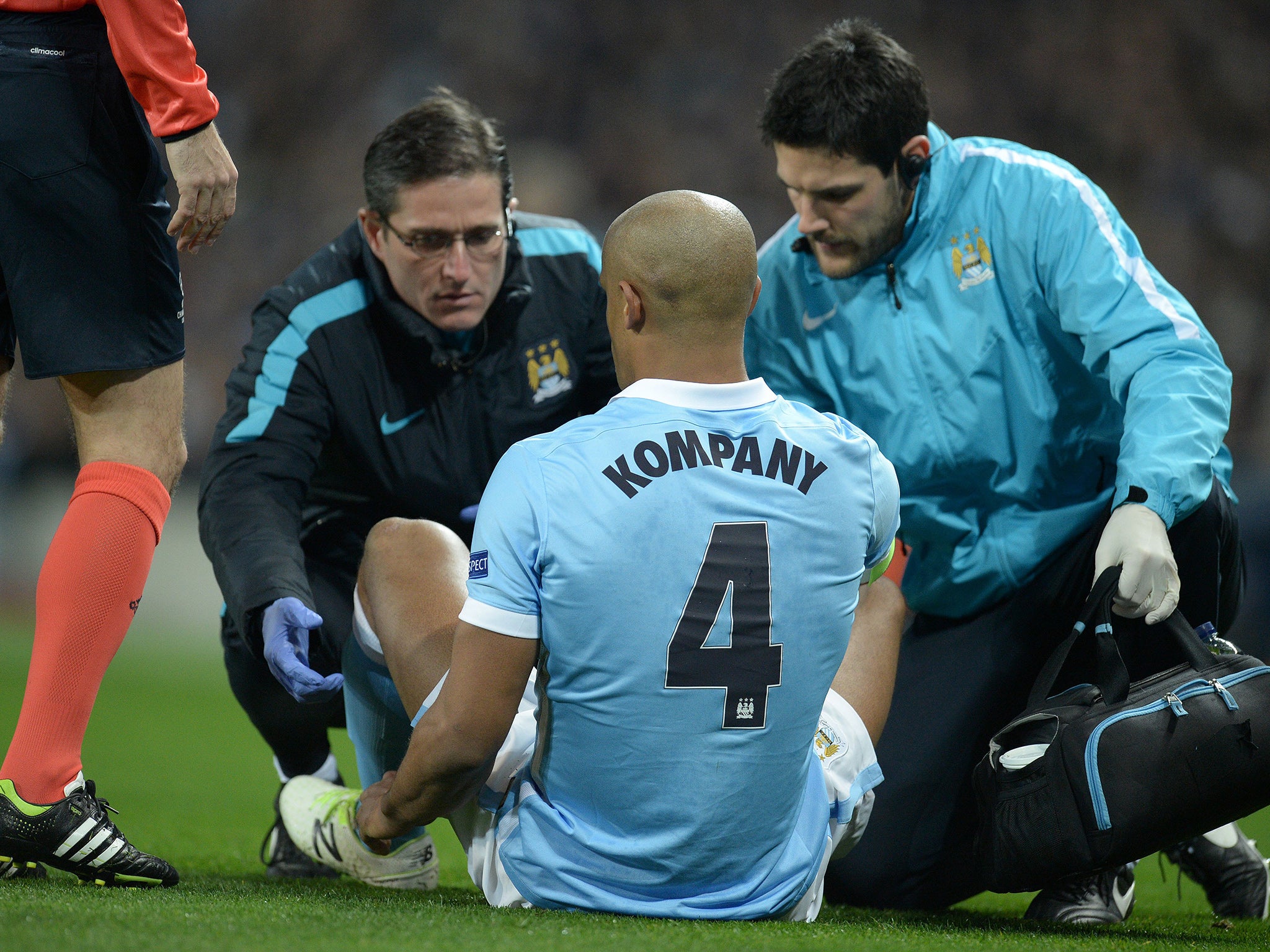 Vincent Kompany receives medical attention before leaving the pitch