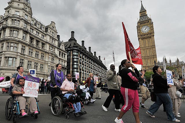 Disability rights protestors demonstrate past the Houses of Parliament, in central London