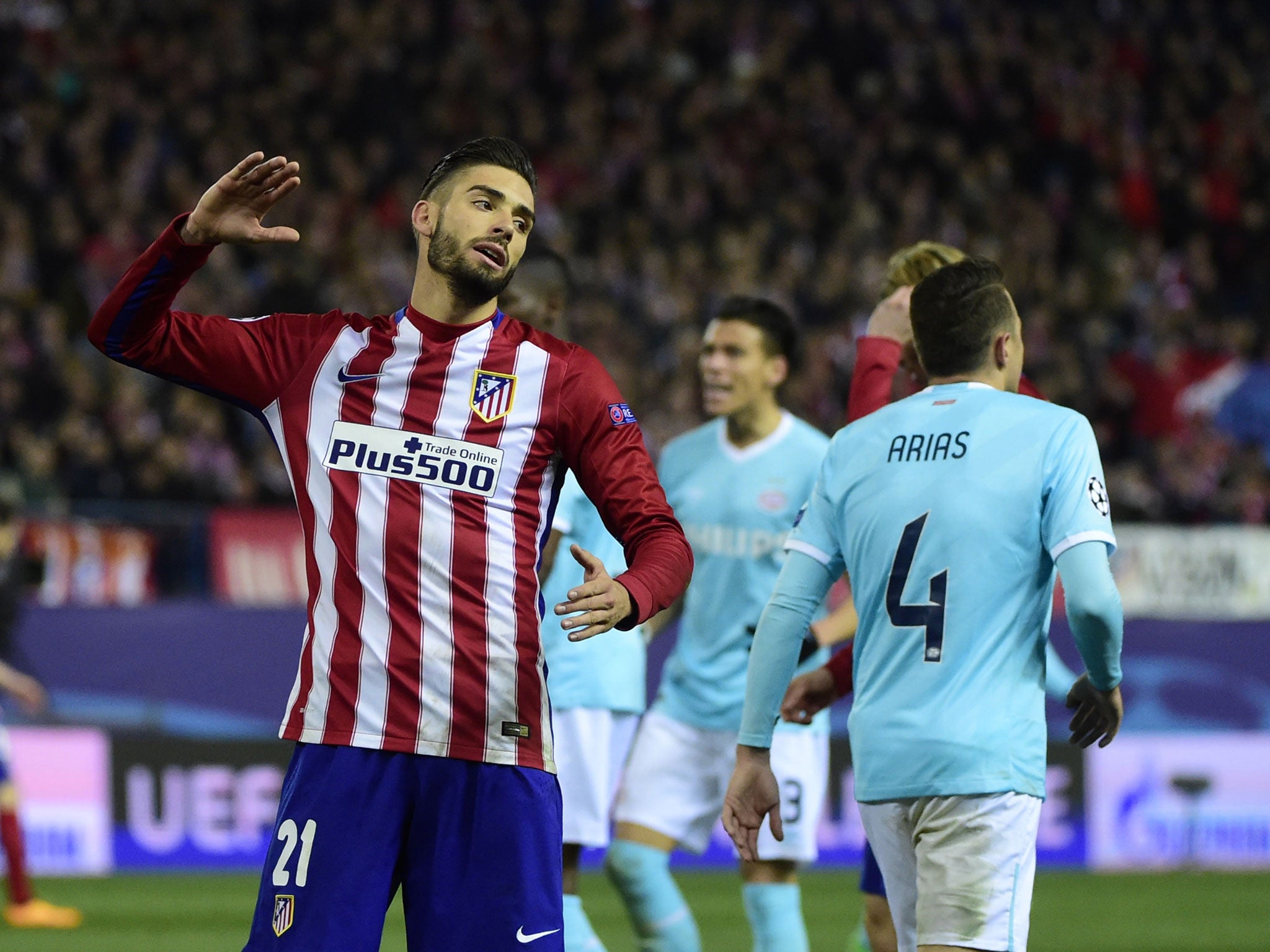 Atletico Madrid's Belgian midfielder Yannick Ferreira Carrasco gestures beside PSV Eindhoven's midfielder Marco van Ginkel