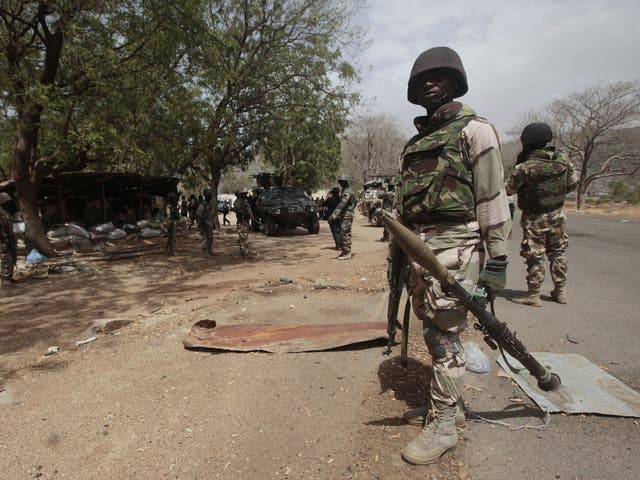 File image: Nigerian soldiers man a checkpoint in Gwoza, Nigeria, a town newly liberated from Boko Haram in April 2015