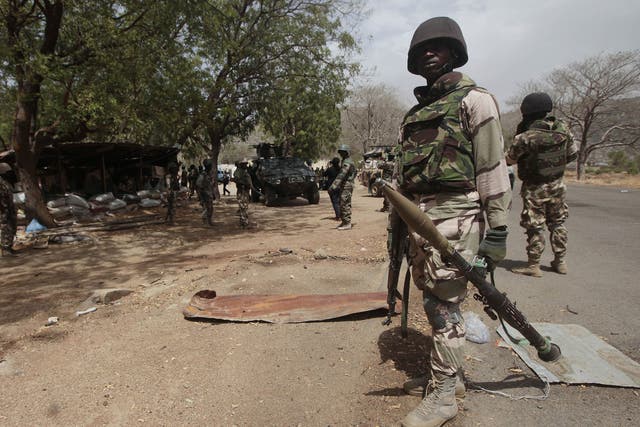 File image: Nigerian soldiers man a checkpoint in Gwoza, Nigeria, a town newly liberated from Boko Haram in April 2015