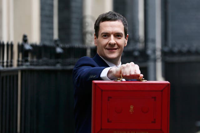 Britain's Chancellor of the Exchequer, George Osborne, holds up his budget case for the cameras as he stands outside number 11 Downing Street, before delivering his budget to the House of Commons