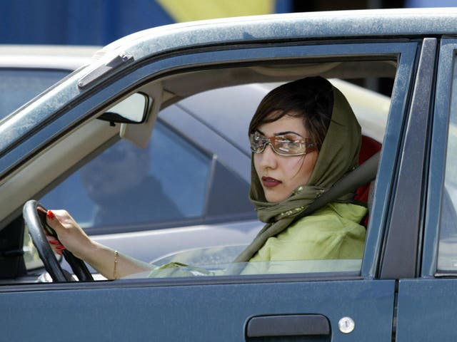 An Iranian woman drives her car in the wealthy area north of Tehran