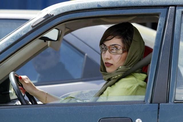 An Iranian woman drives her car in the wealthy area north of Tehran