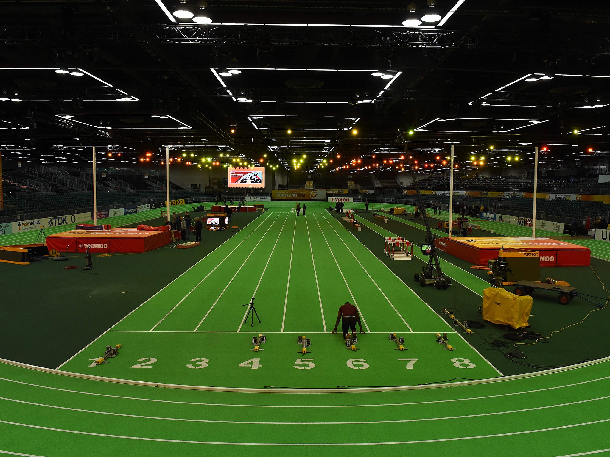 An athlete checks the track before the ISSF World Indoor athletic championships in Portland, Oregon