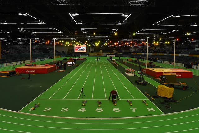 An athlete checks the track before the ISSF World Indoor athletic championships in Portland, Oregon