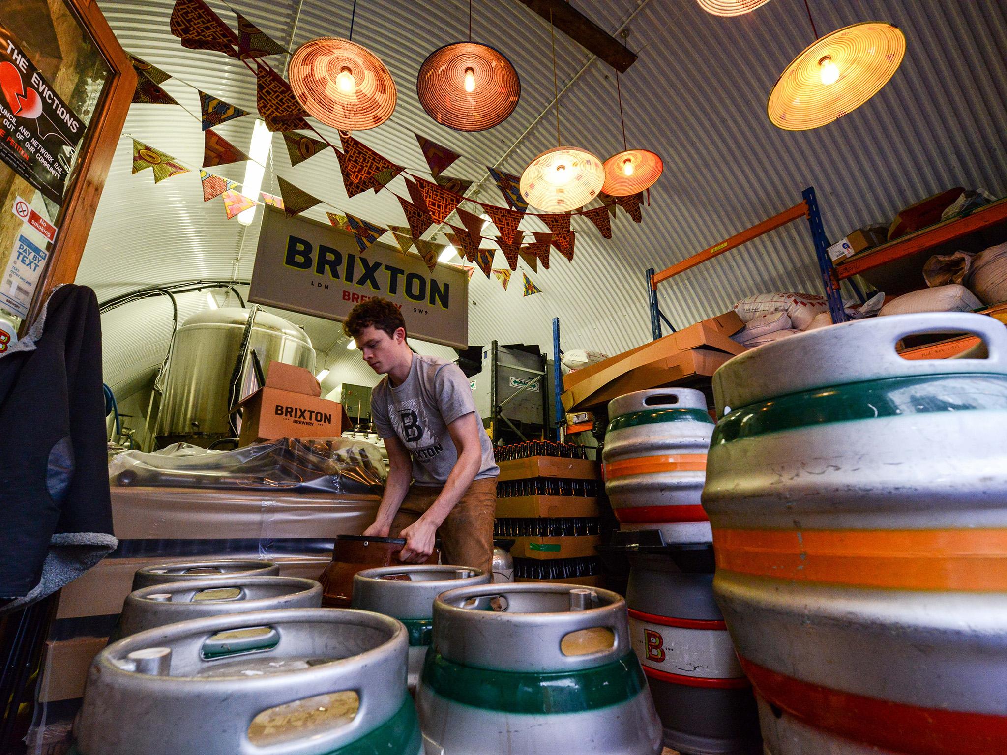 Brewer labels casks full of Effra Ale at inner city craft beer makers Brixton Brewery