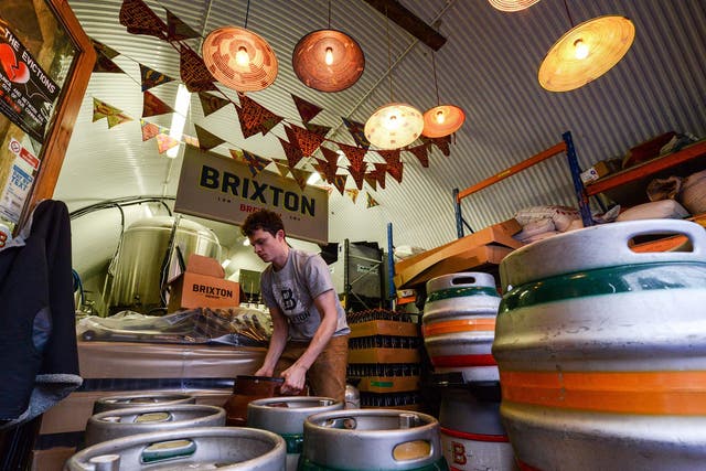 Brewer labels casks full of Effra Ale at inner city craft beer makers Brixton Brewery