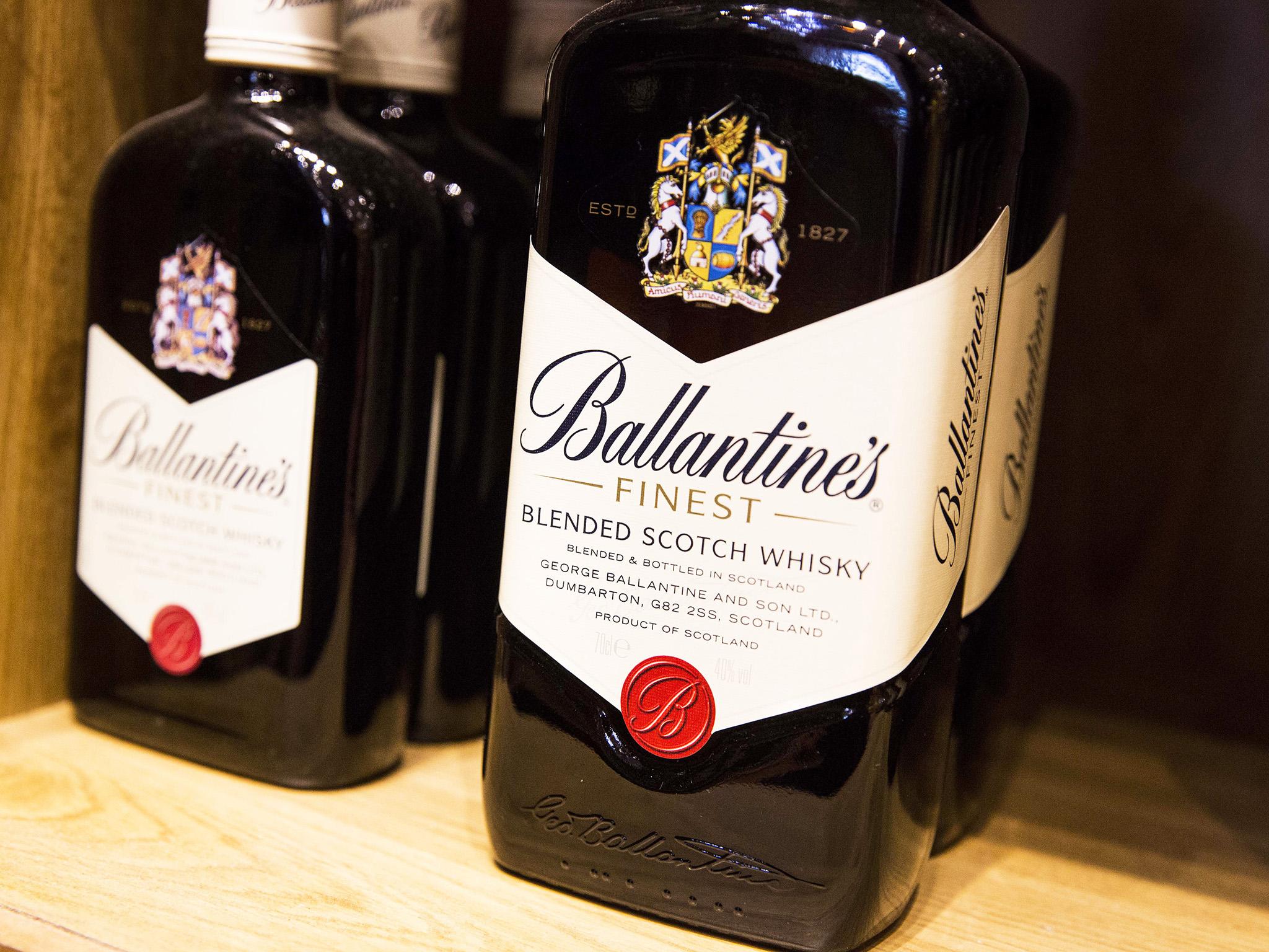 Bottles of Ballantines scotch whiskey, produced by Pernod Ricard SA, sits on a shelf in a restaurant in Paris, France