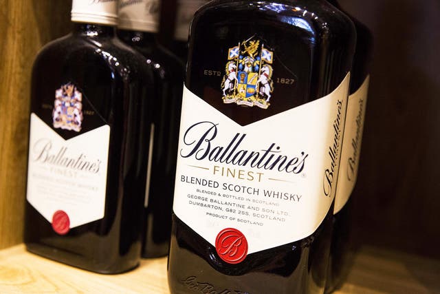 Bottles of Ballantines scotch whiskey, produced by Pernod Ricard SA, sits on a shelf in a restaurant in Paris, France