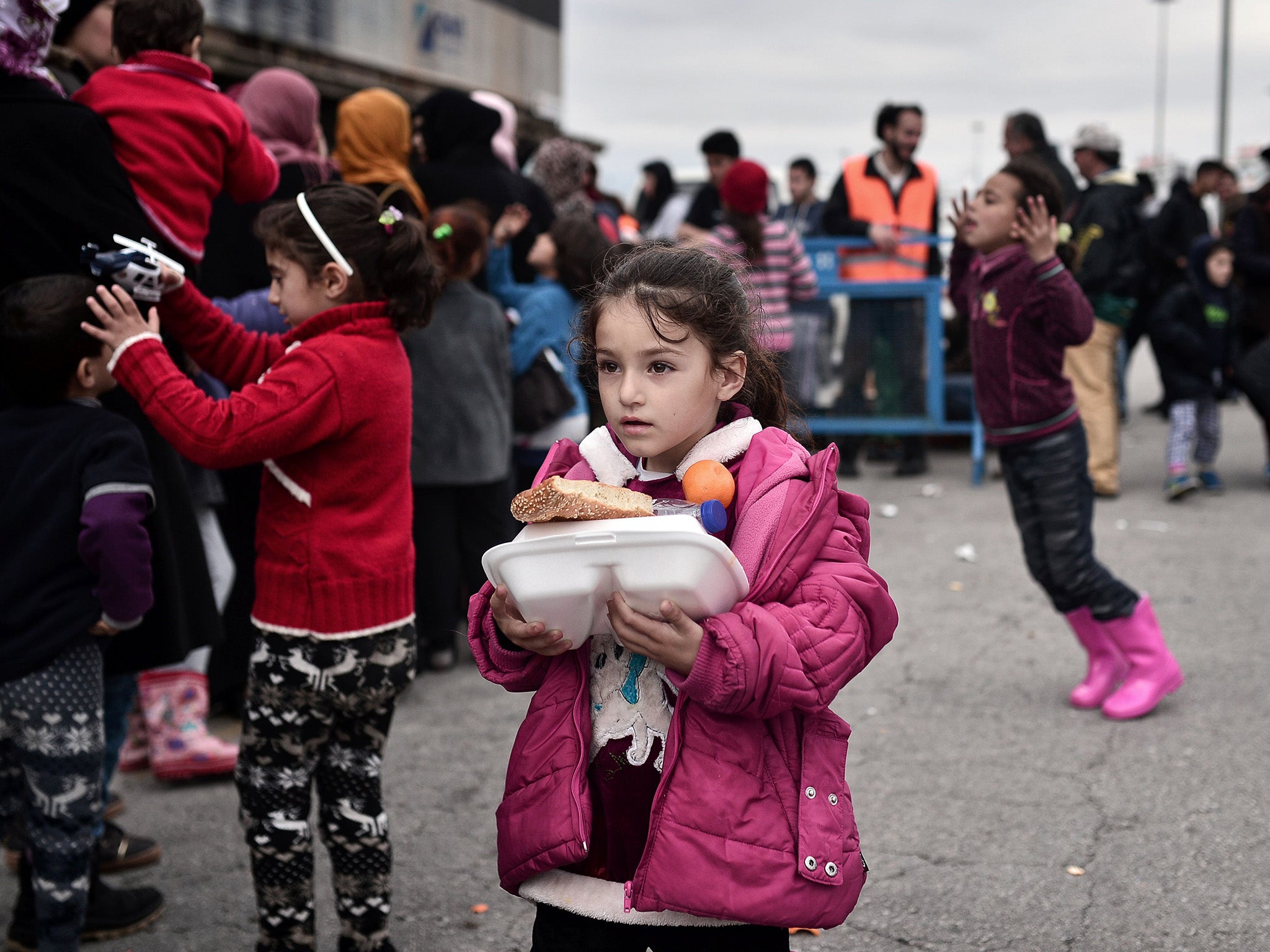 Refugee child receiving rations in Greece