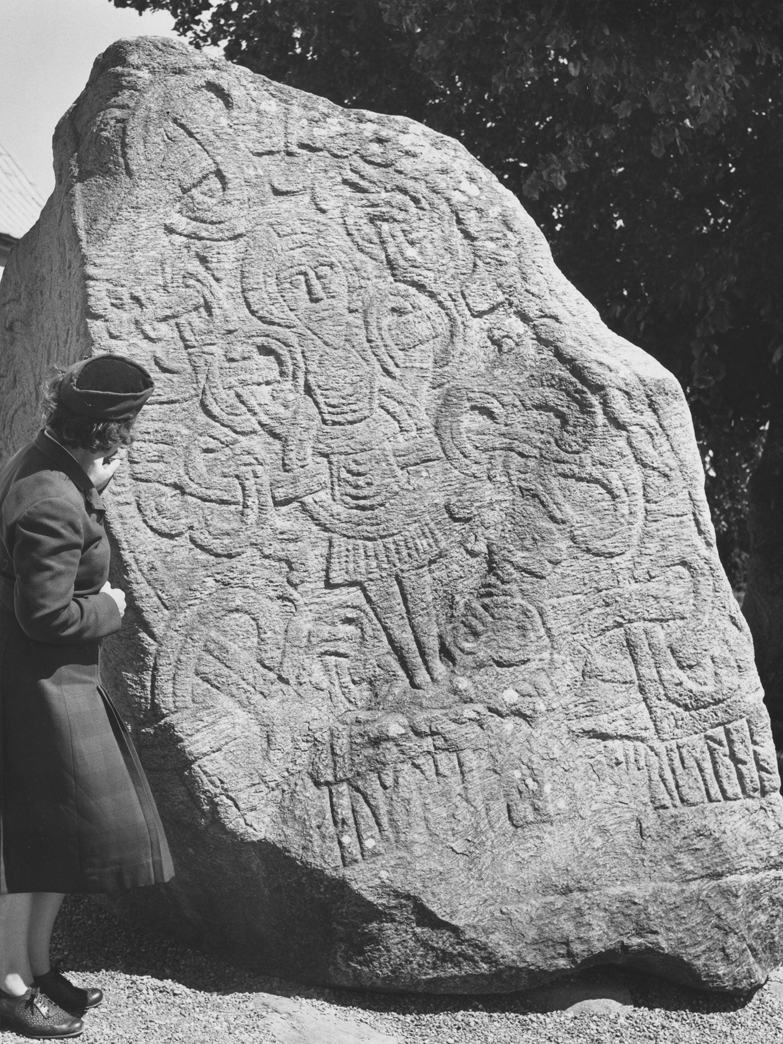 One of the rune stones at Jelling, Jutland. A figure with arms outstretched as if on a crucifix can be seen.
