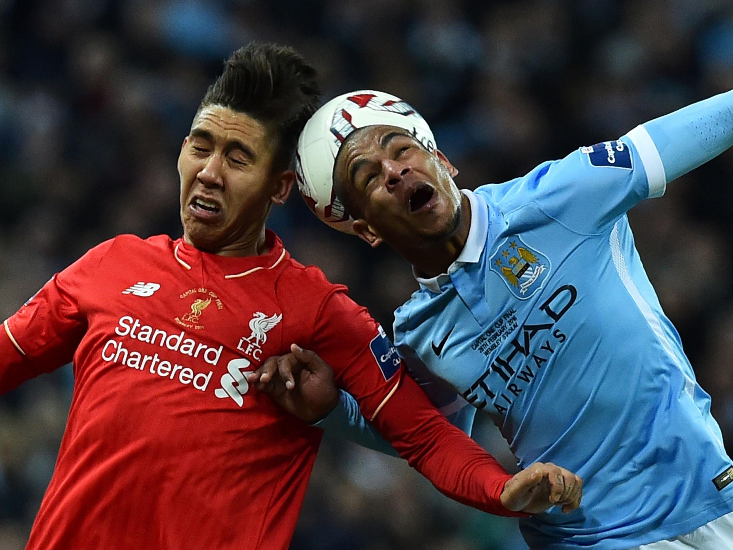 Manchester City's Fernando does battle with Liverpool's Roberto Firmino