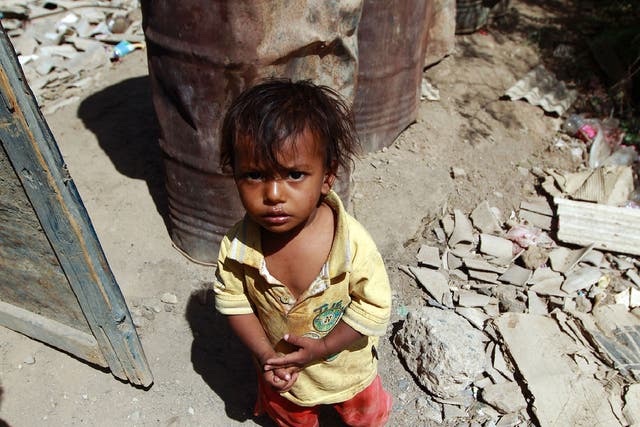 A Yemeni child stands outside the family house which was destroyed several months ago in an air-strike by the Saudi-led coalition at a slum in the capital Sanaa