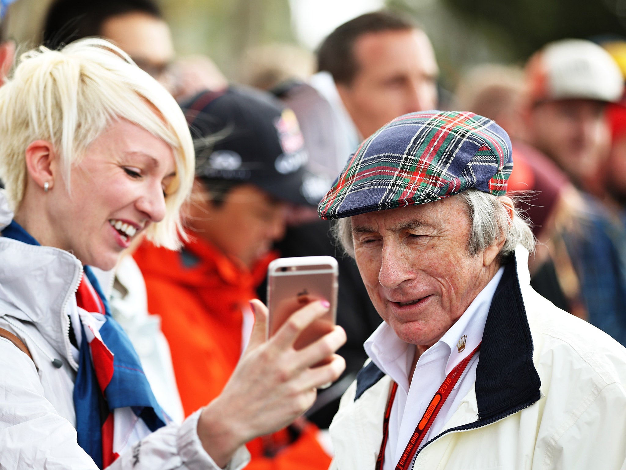 Sir Jackie Stewart takes pictures with fans in Melbourne