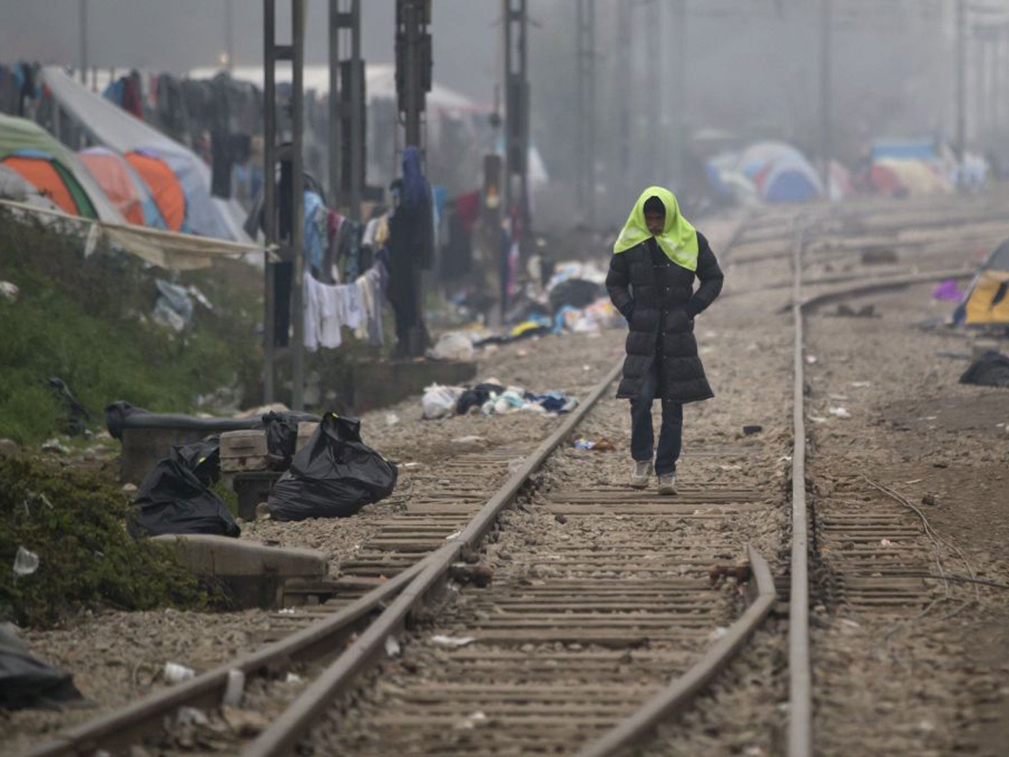 A migrant man walks on railway tracks at the northern Greek border point of Idomeni, Greece