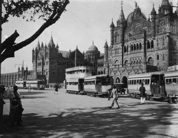 Trams passing the grand facade of Victoria Railway Station in Bombay, 1915.