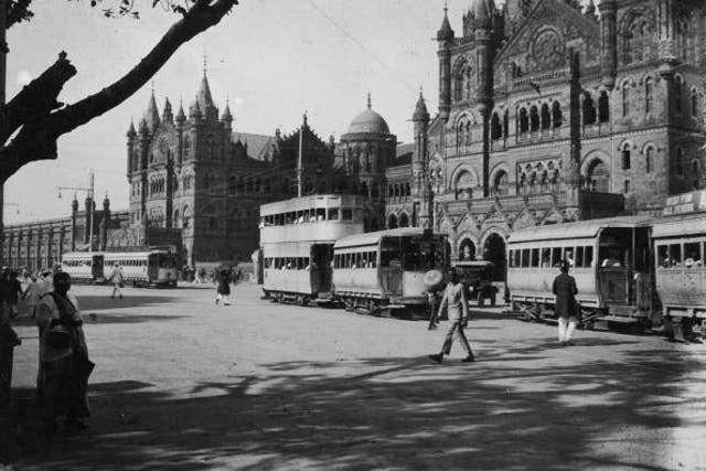 Trams passing the grand facade of Victoria Railway Station in Bombay, 1915.