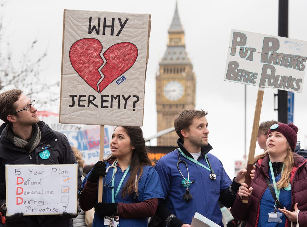 Junior doctors protest with banners outside St Thomas' Hospital in central London