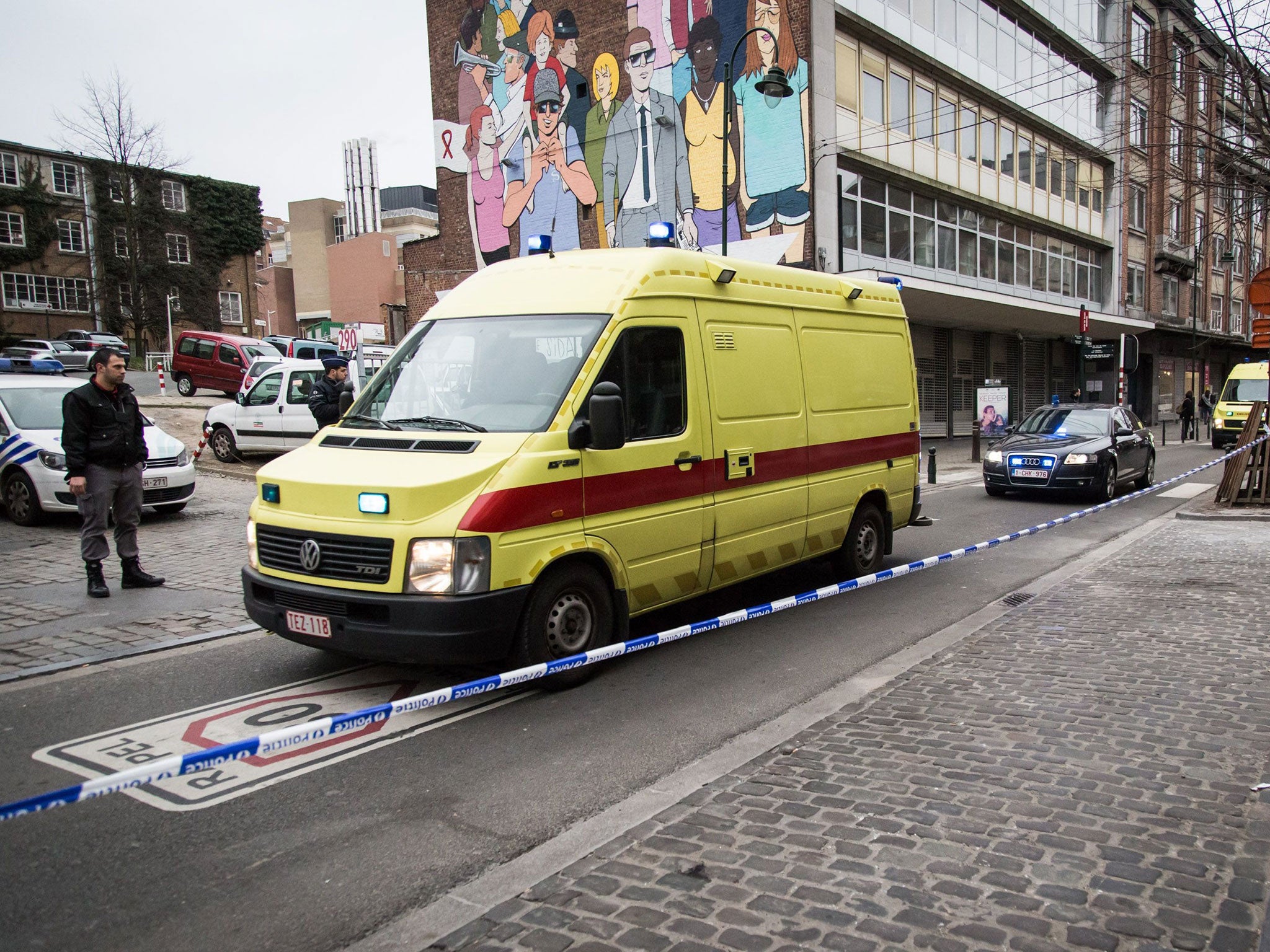 An ambulance leaves Saint-Pierre hospital in Brussels accompanied by a police convoy
