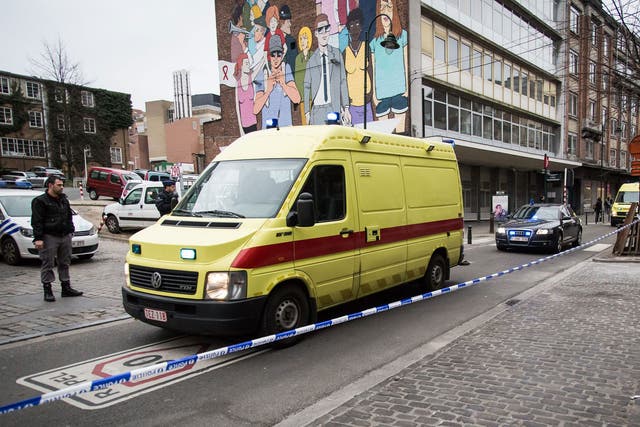 An ambulance leaves Saint-Pierre hospital in Brussels accompanied by a police convoy