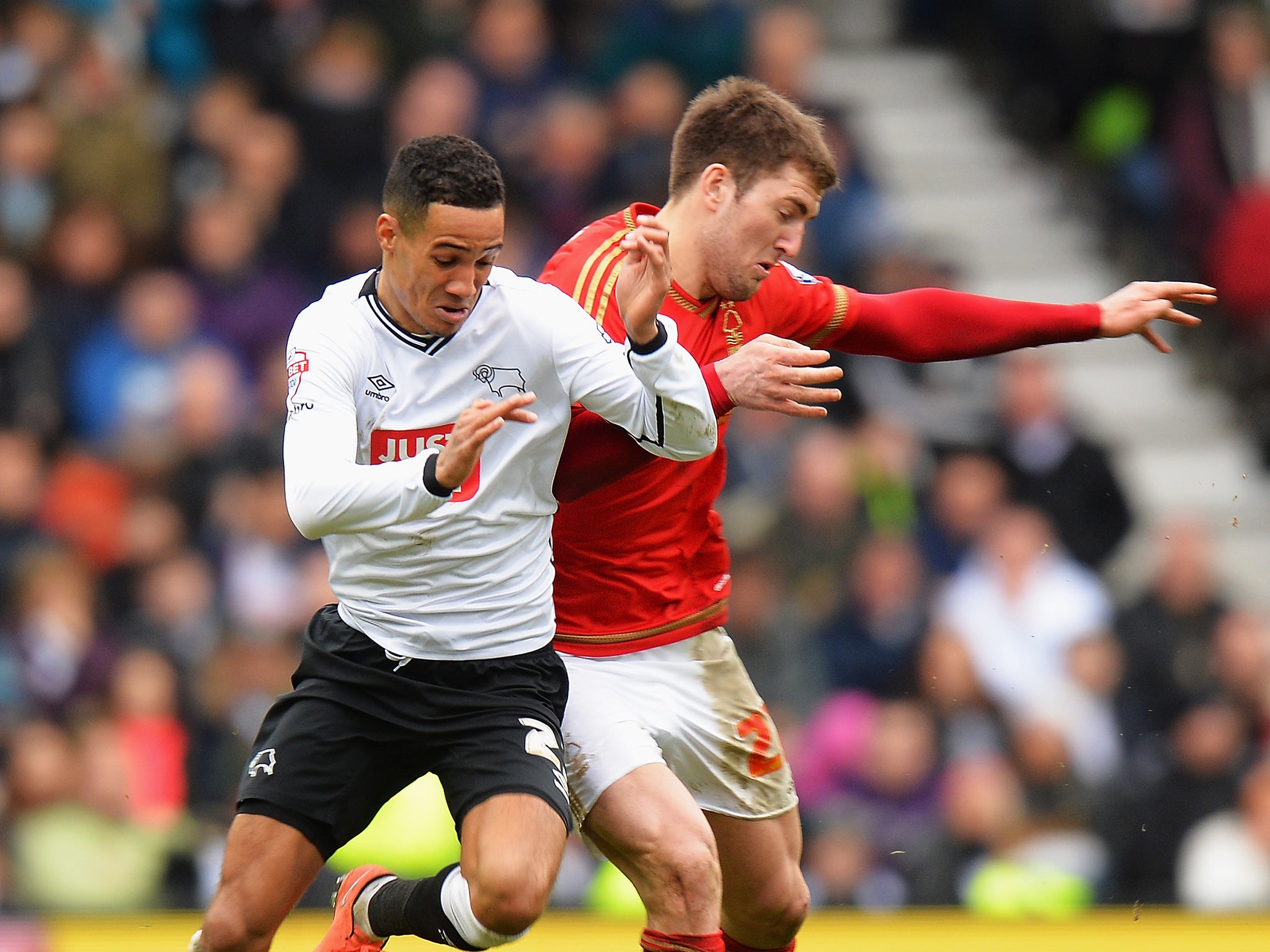 Tom Ince and Gary Gardner battle for the ball
