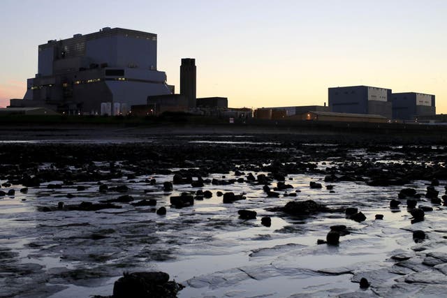 The sun sets on the existing Hinkley Point nuclear plant in Somerset